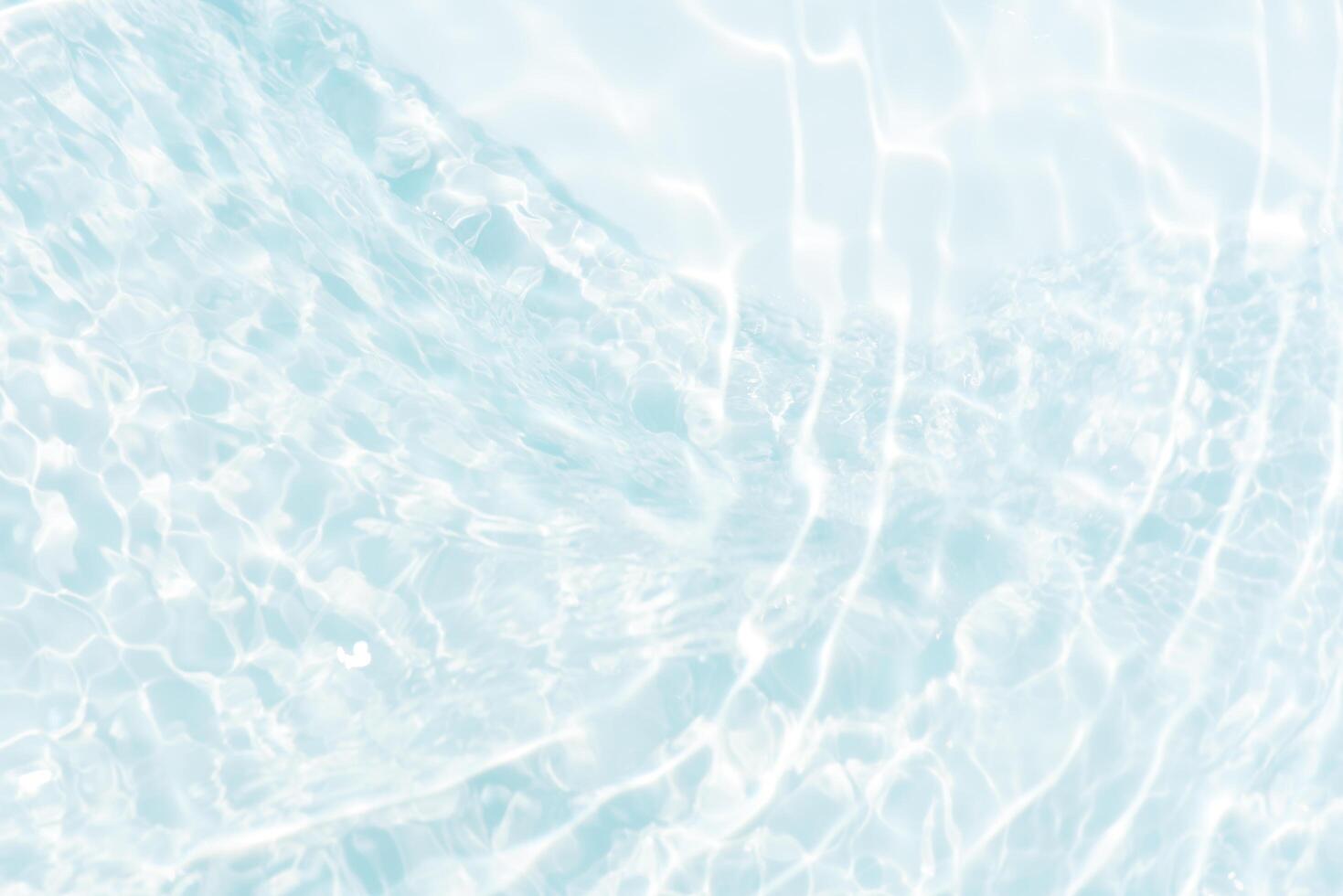 Blue water with ripples on the surface. Defocus blurred transparent blue colored clear calm water surface texture with splashes and bubbles. Water waves with shining pattern texture background. photo