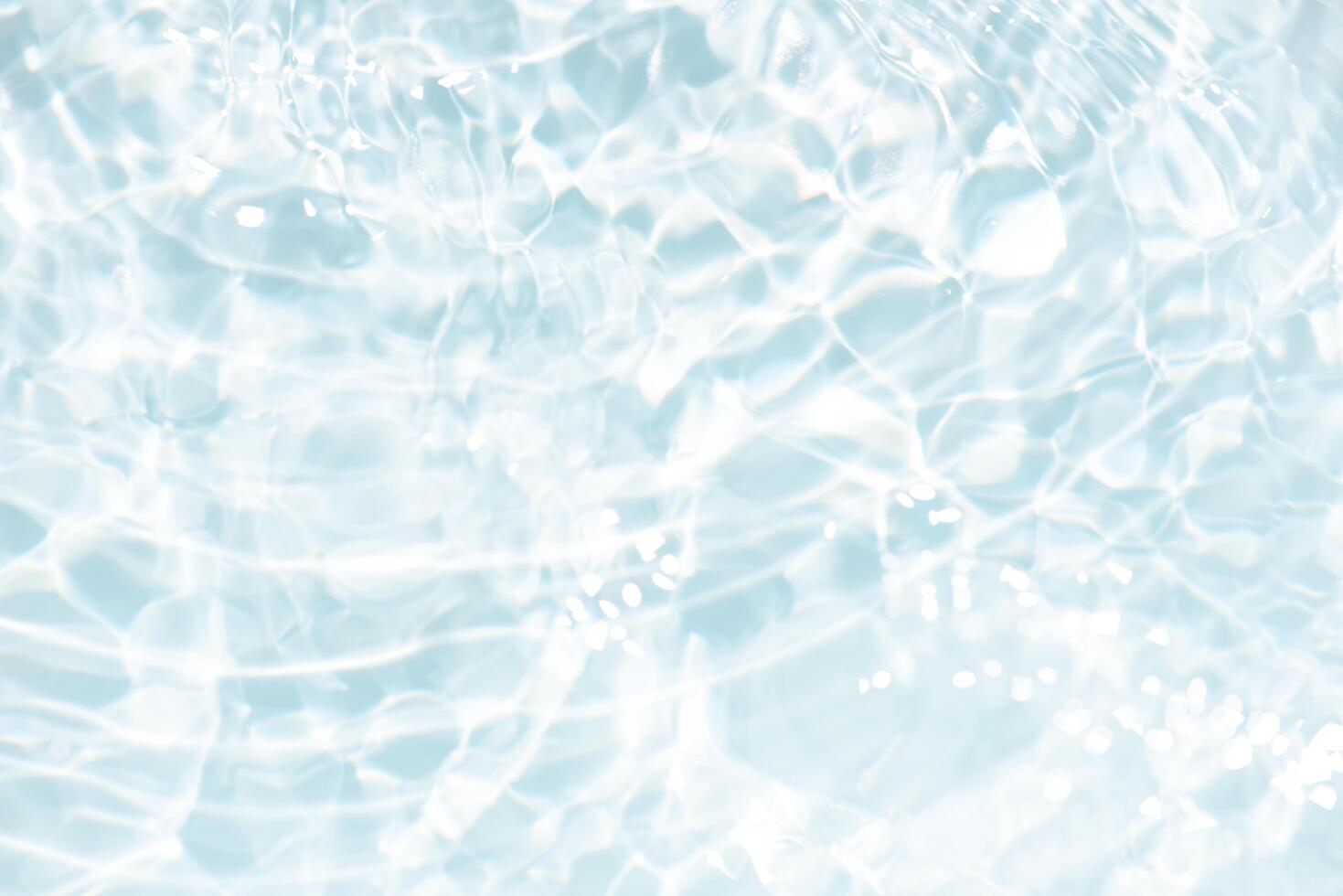 Bluewater waves on the surface ripples blurred. Defocus blurred transparent blue colored clear calm water surface texture with splash and bubbles. Water waves with shining pattern texture background. photo