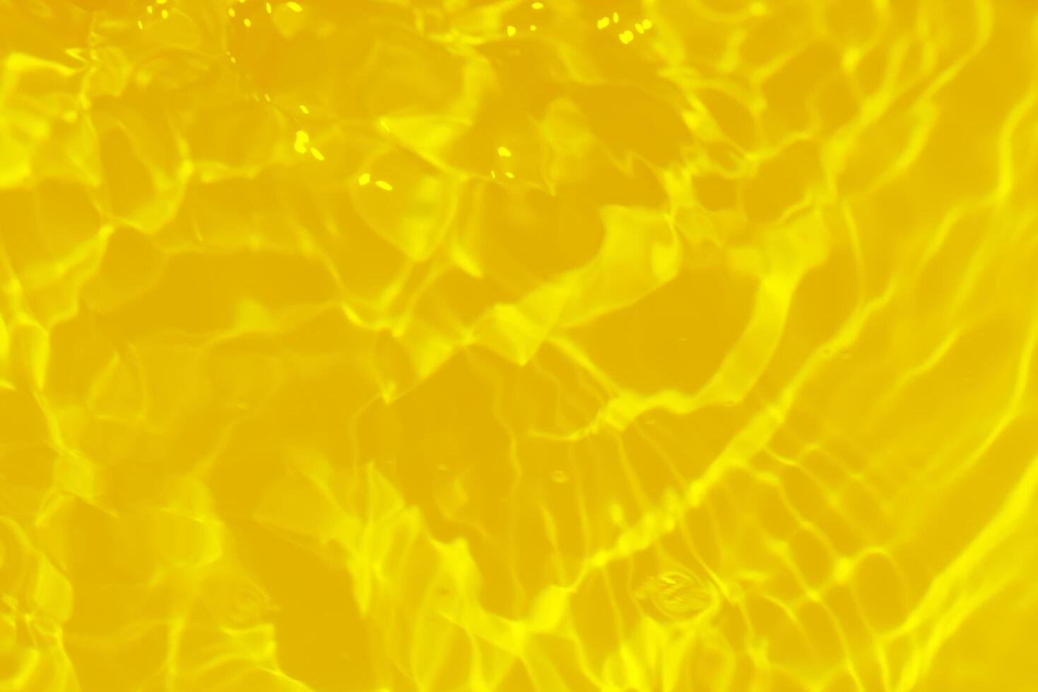 Blue water with ripples on the surface. Defocus blurred transparent blue colored clear calm water surface texture with splashes and bubbles. Water waves with shining pattern texture background. photo