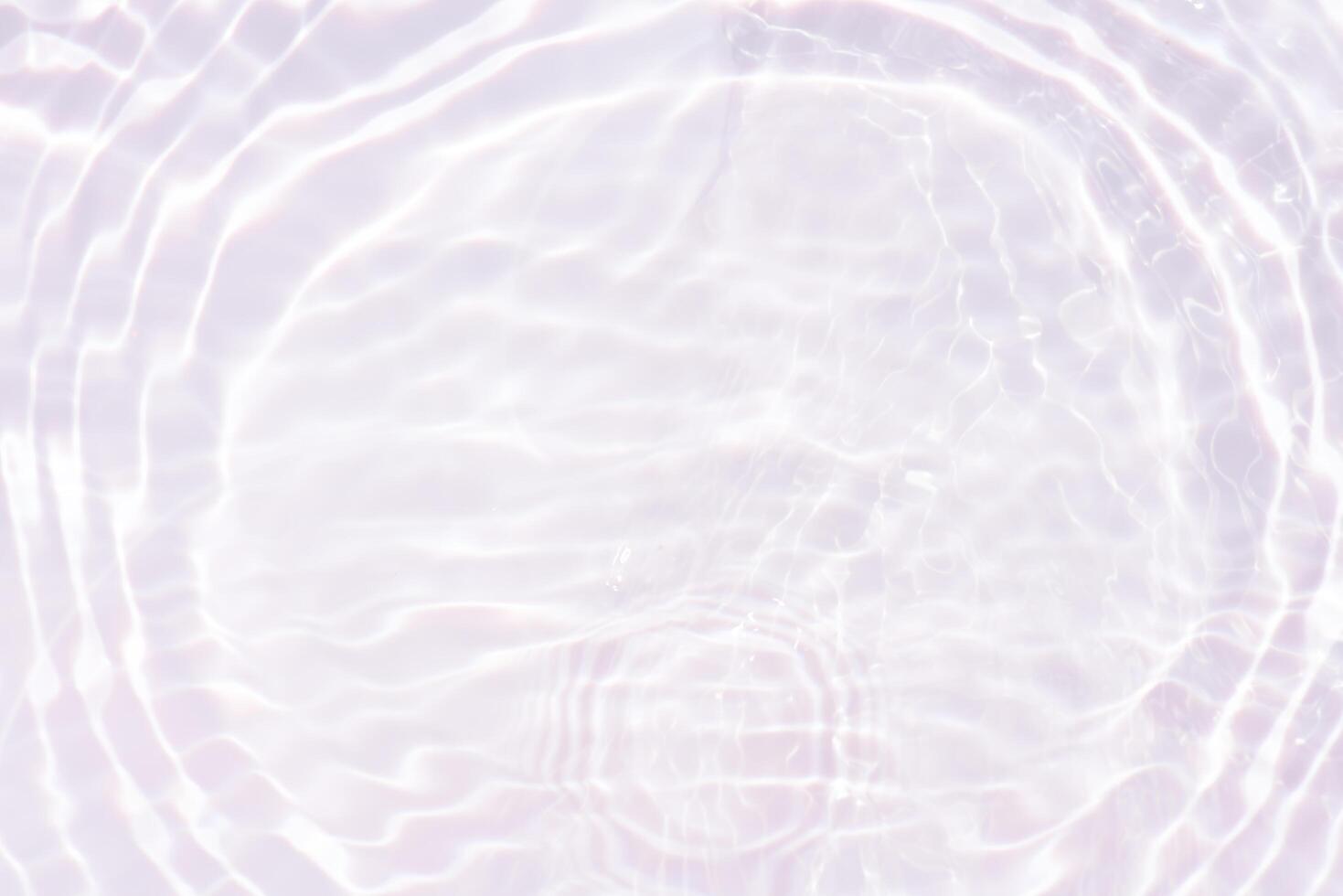 Bluewater waves on the surface ripples blurred. Defocus blurred transparent blue colored clear calm water surface texture with splash and bubbles. Water waves with shining pattern texture background. photo