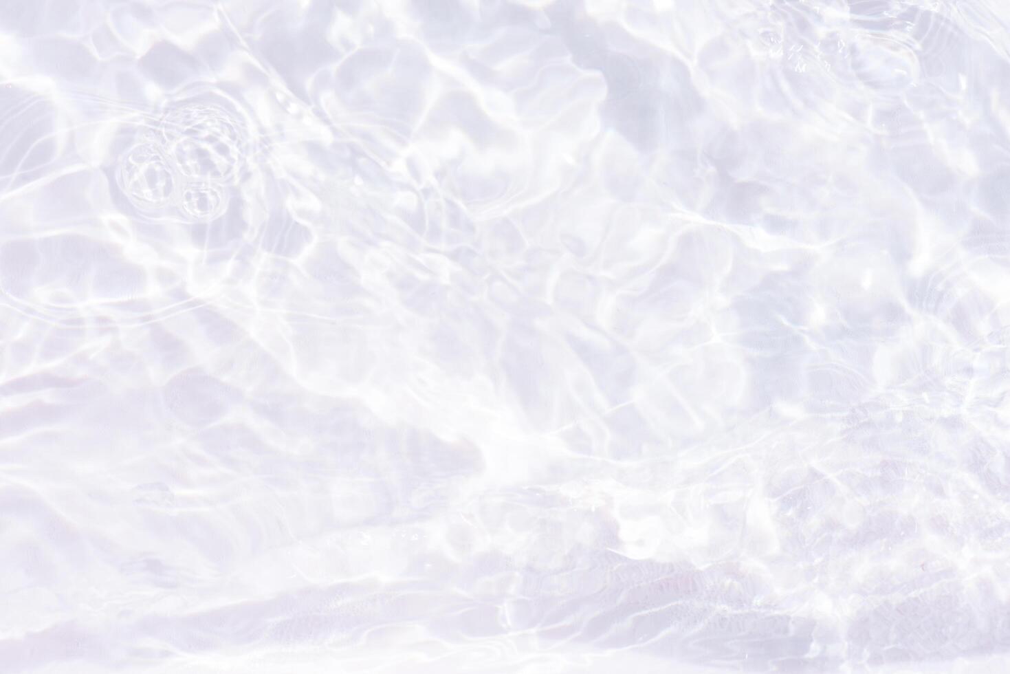 Bluewater waves on the surface ripples blurred. Defocus blurred transparent blue colored clear calm water surface texture with splash and bubbles. Water waves with shining pattern texture background. photo