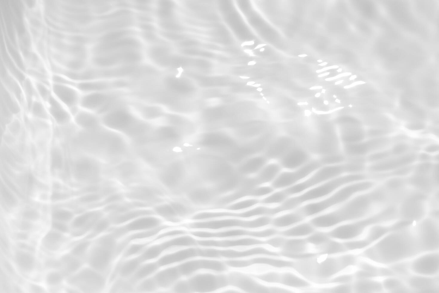 Blue water with ripples on the surface. Defocus blurred transparent blue colored clear calm water surface texture with splashes and bubbles. Water waves with shining pattern texture background. photo