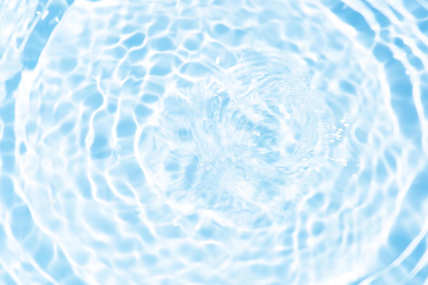 Bluewater waves on the surface ripples blurred. Defocus blurred transparent blue colored clear calm water surface texture with splash and bubbles. Water waves with shining pattern texture background. photo