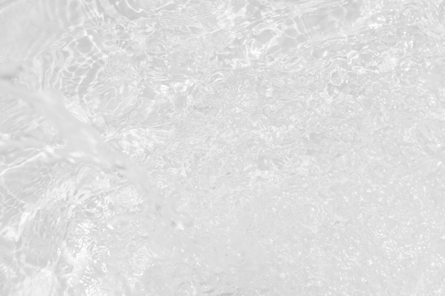 Blue water with ripples on the surface. Defocus blurred transparent blue colored clear calm water surface texture with splashes and bubbles. Water waves with shining pattern texture background. photo