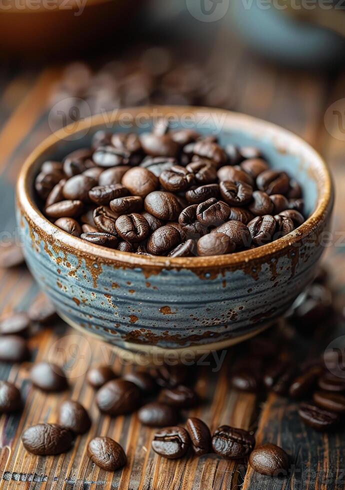 A bowl of coffee beans is on a wooden table photo