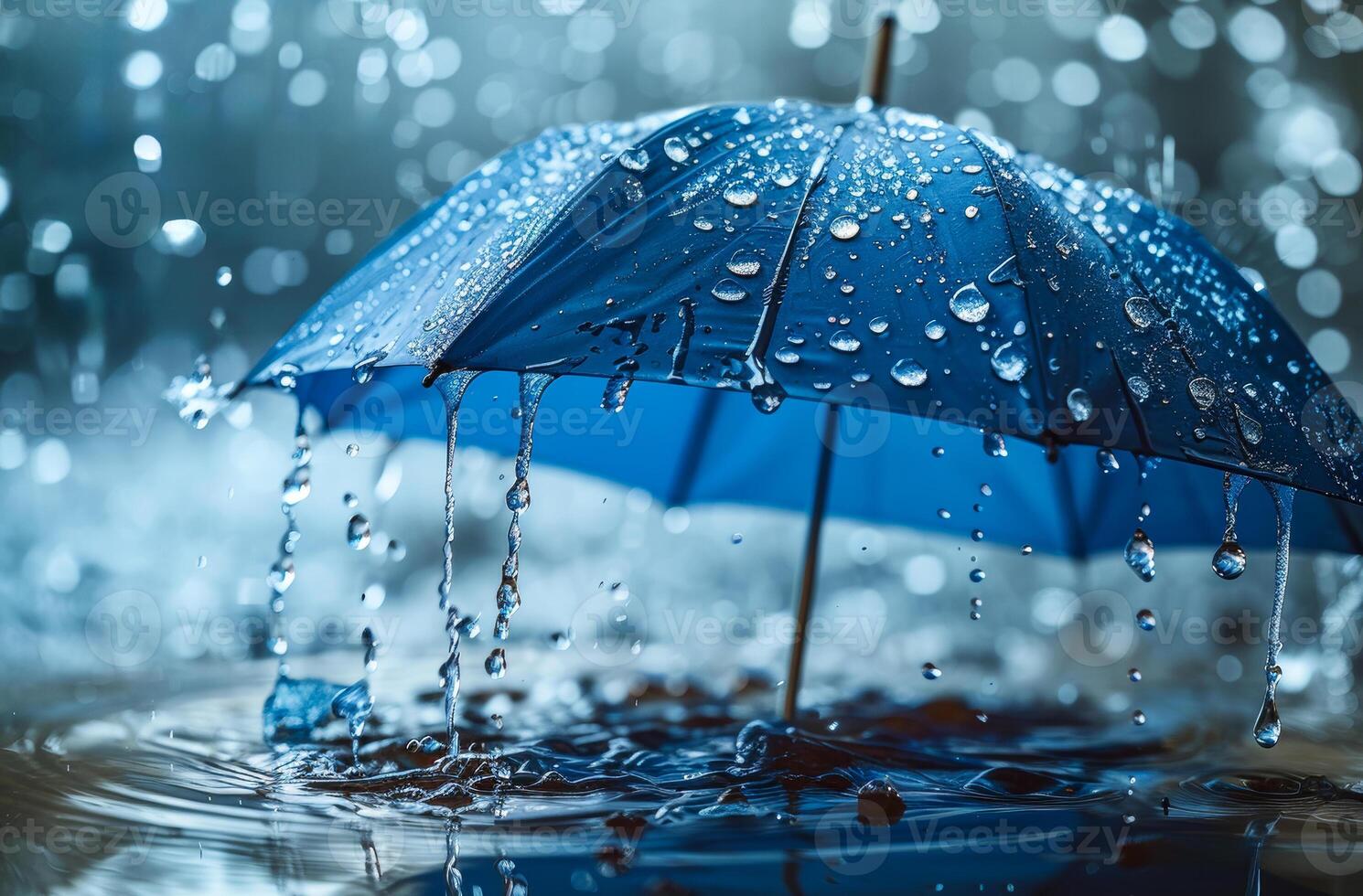 Blue umbrella with water drops close up in the rain with beautiful bokeh light photo