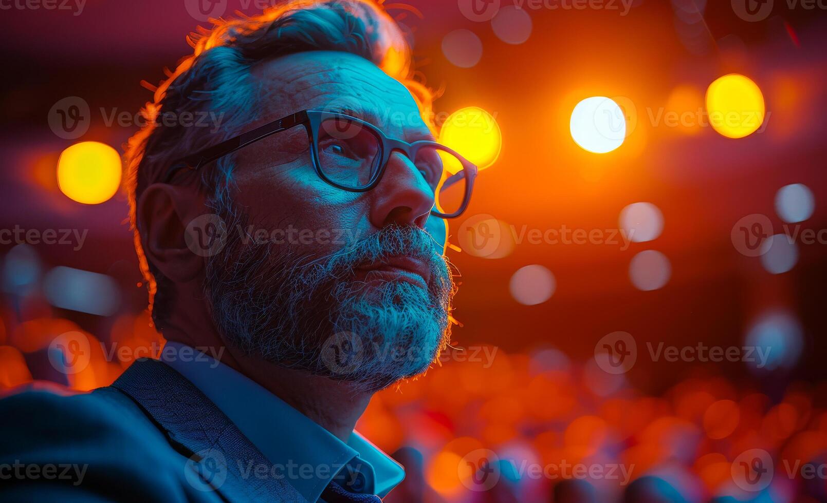 Close-up portrait of bearded man in eyeglasses watching the theater photo