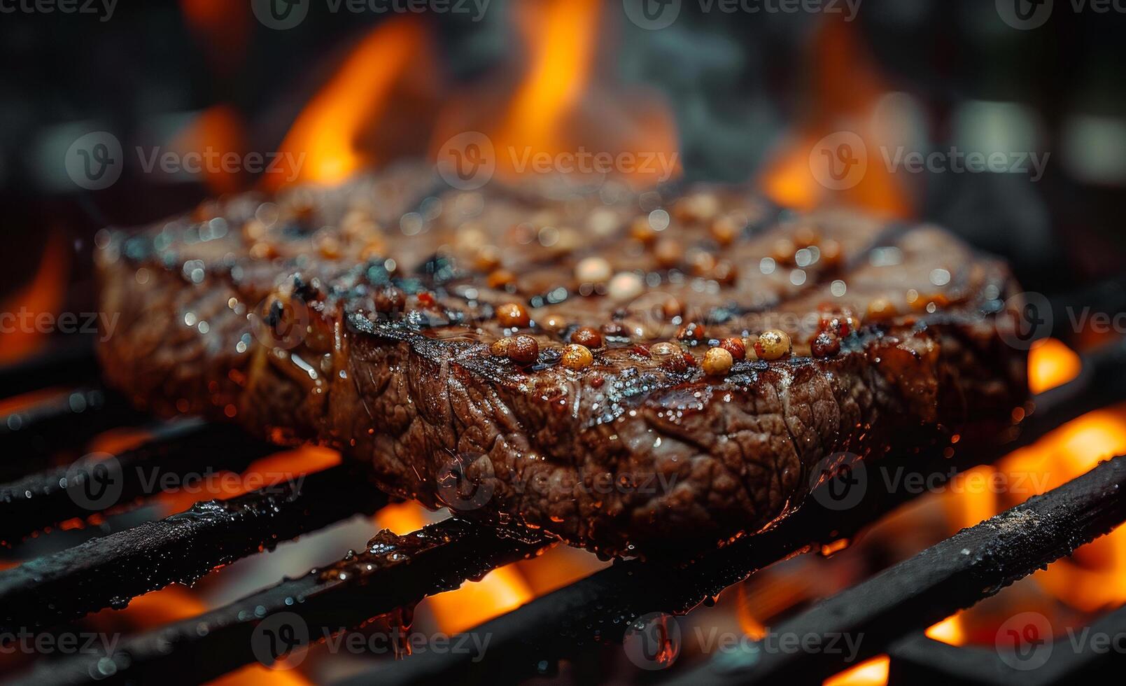 Beef steak on the grill with flames. A grilling steaks on flaming grill photo