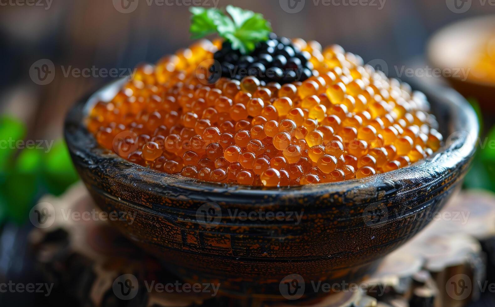 Red and black caviar in bowl on wooden table photo