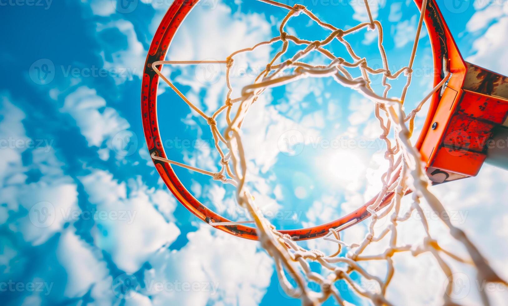 Basketball hoop and the sky. Closeup of a basketball going through the net photo
