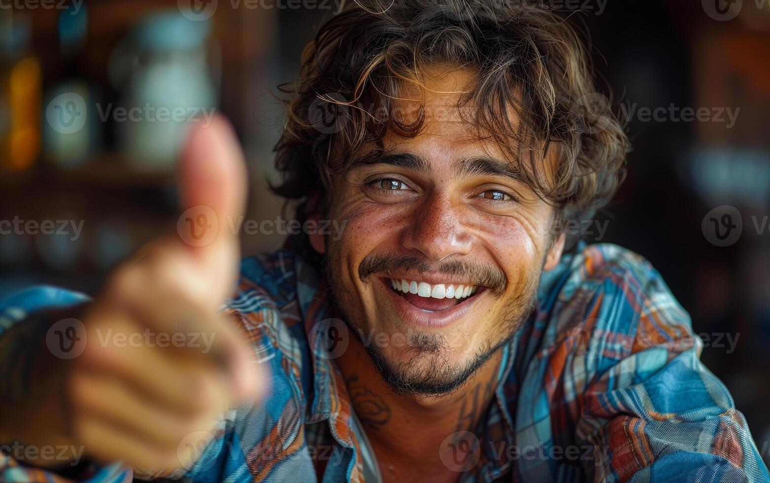 Portrait of young man with thumbs up. A man pointing at the camera photo