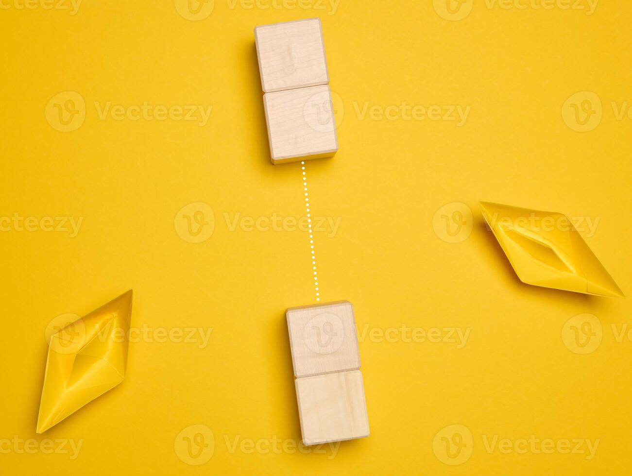 Two yellow paper boats and a barrier between them. Concept of searching for compromises photo
