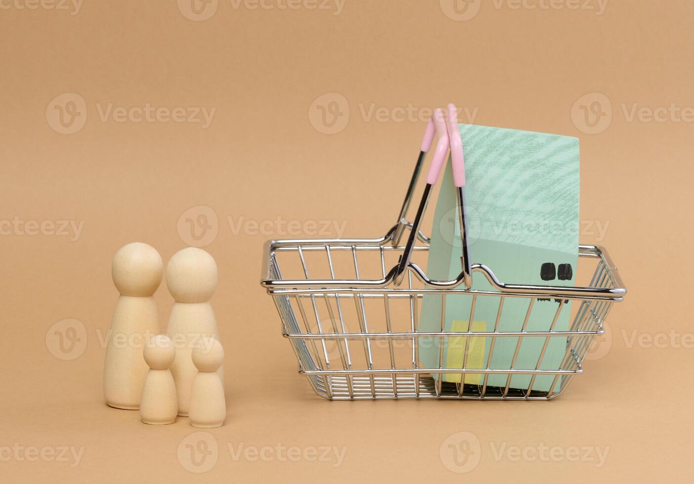 A wooden house in a miniature cart and wooden men of a family with children. photo