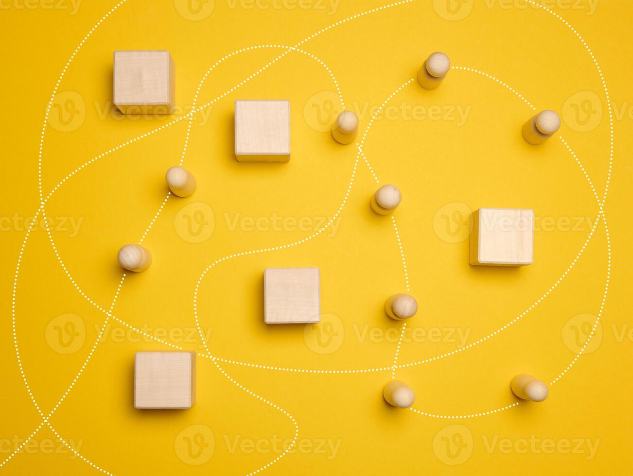 Wooden figures of men and a trajectory between obstacles on a yellow background photo