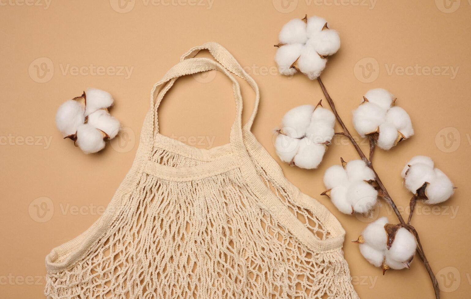 Textile grocery bag on brown background, top view photo