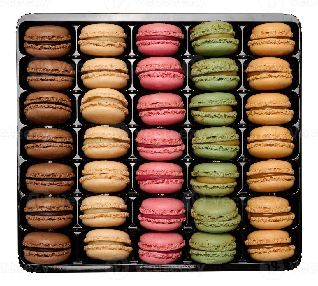 Multi-colored macarons in a plastic box, top view. Assortment photo
