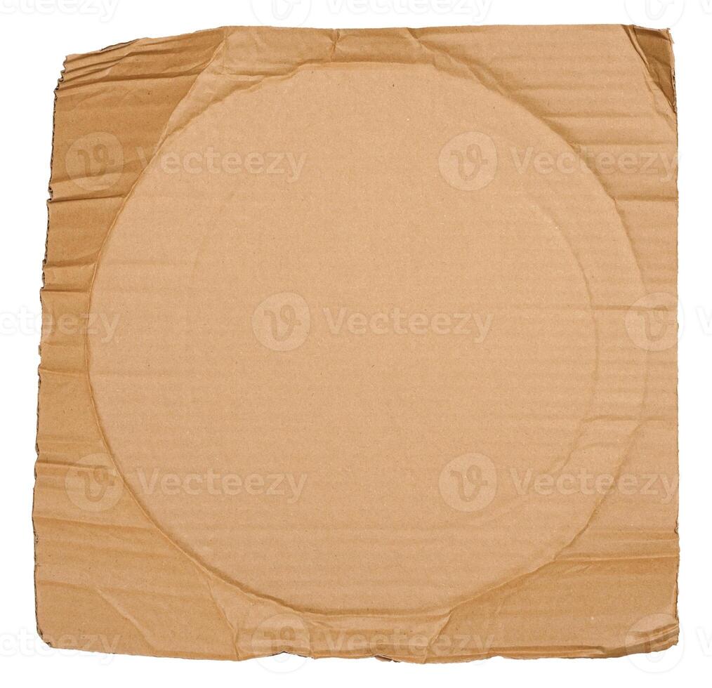 Piece of brown cardboard with torn edges on isolated background photo
