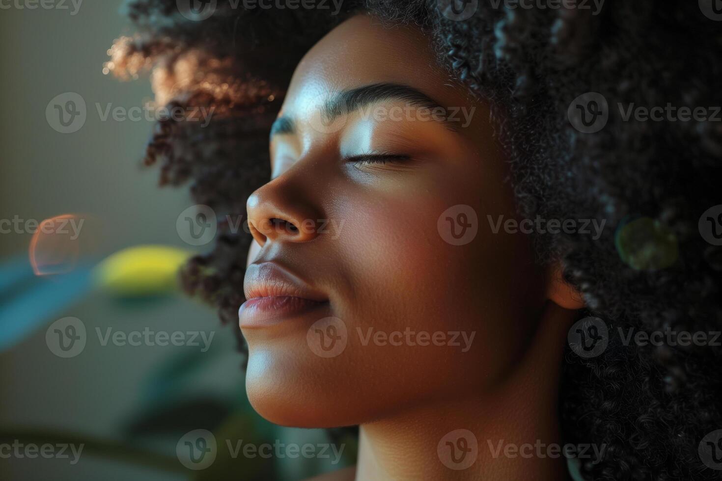 Close-up of a young woman with eyes closed, bathed in warm sunlight, with a sense of calm and peace photo