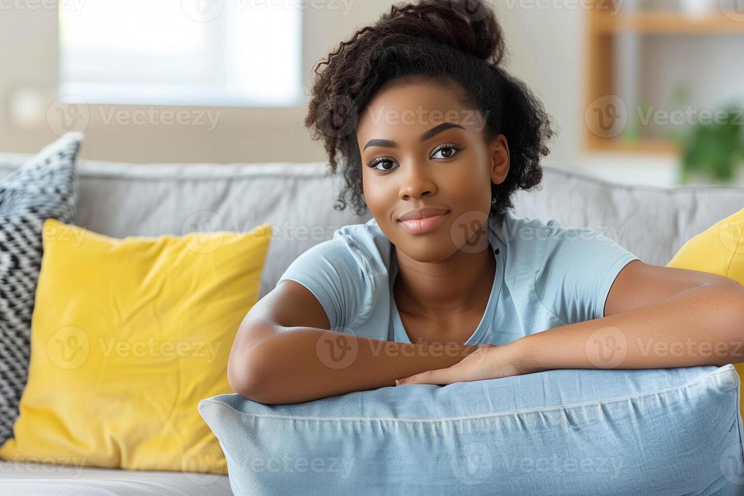 A serene client relaxes on a sofa, ready for an online therapy session photo