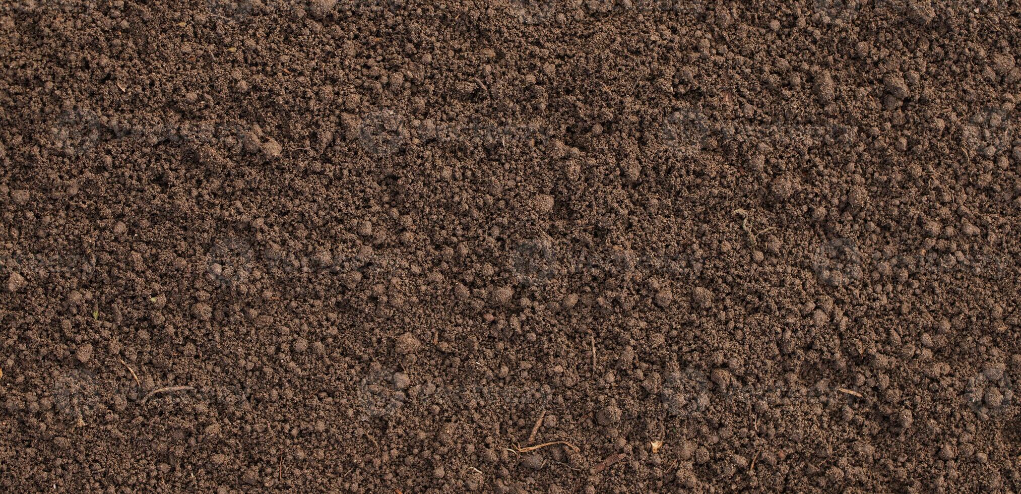 loosened soil as a background. brown ground surface photo