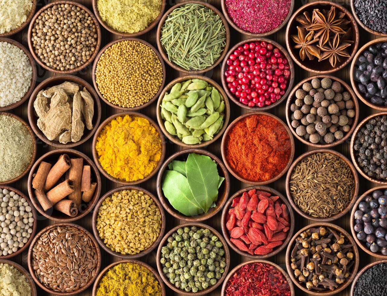 Spices and herbs background. Condiments on the table spread out by a rainbow photo