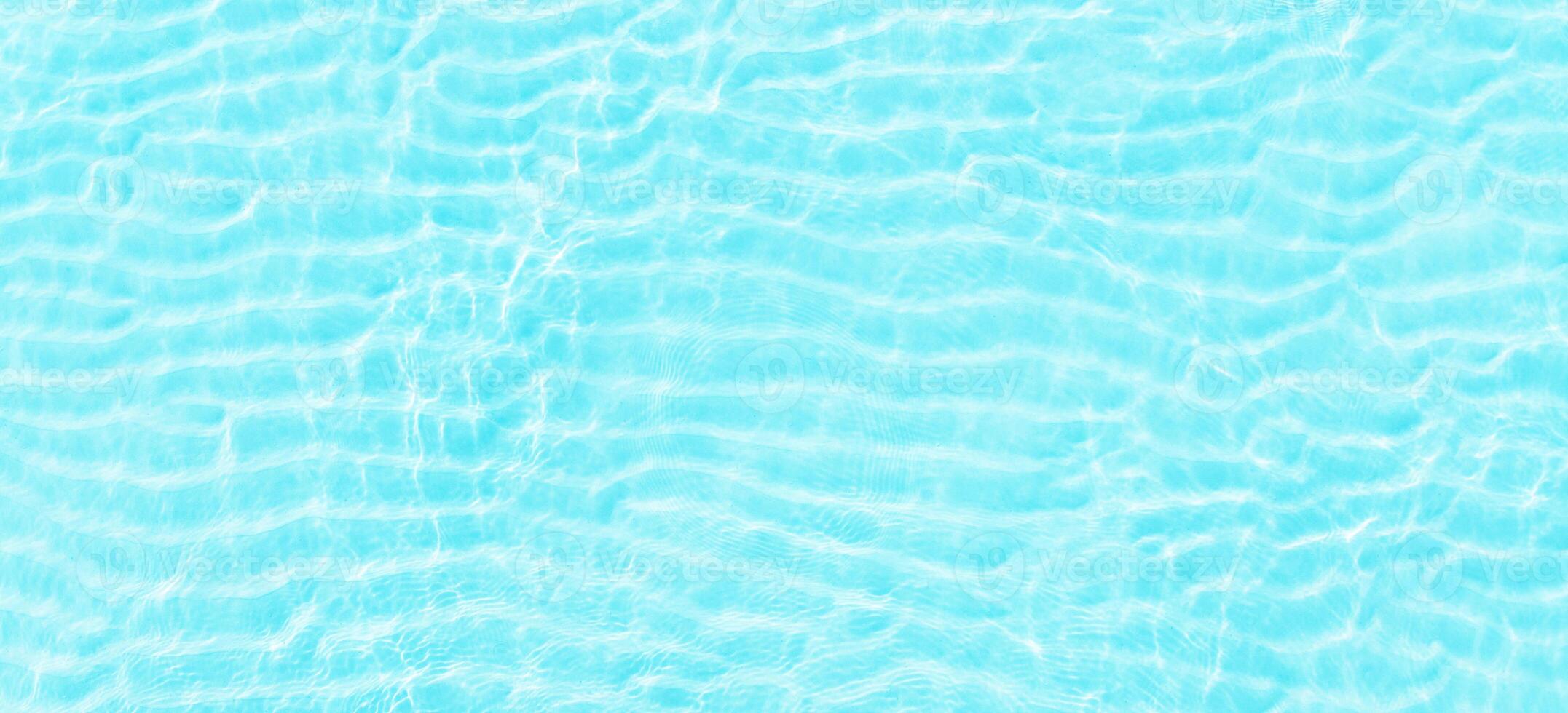 turquoise ocean waves, top view. Blue sea surface with transparent water as background photo