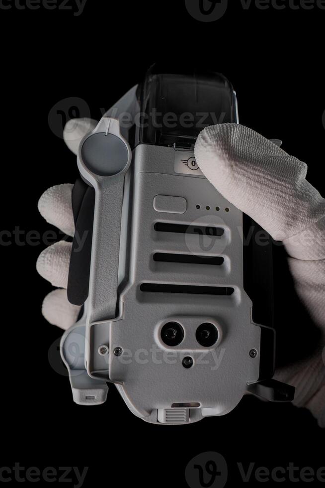 Gloved Hand Holding Drone in Dark photo
