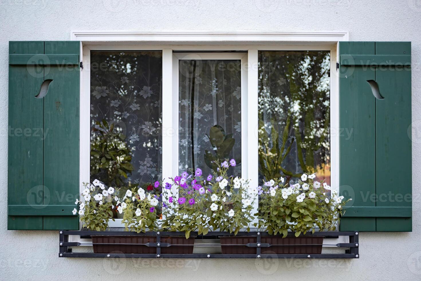 old open window with green shutters and flowers photo