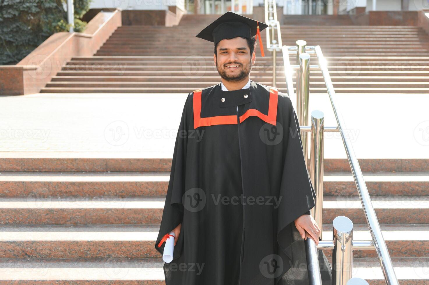 Portrait of happy man, graduation or student in university campus photo