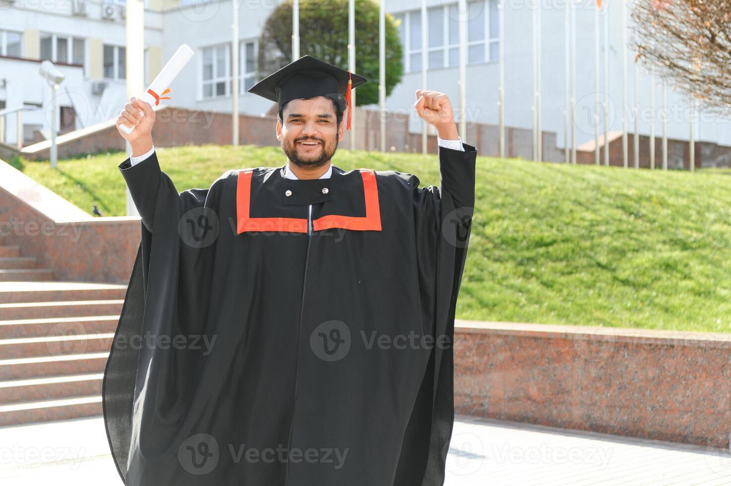 Portrait of happy man, graduation or student in university campus photo