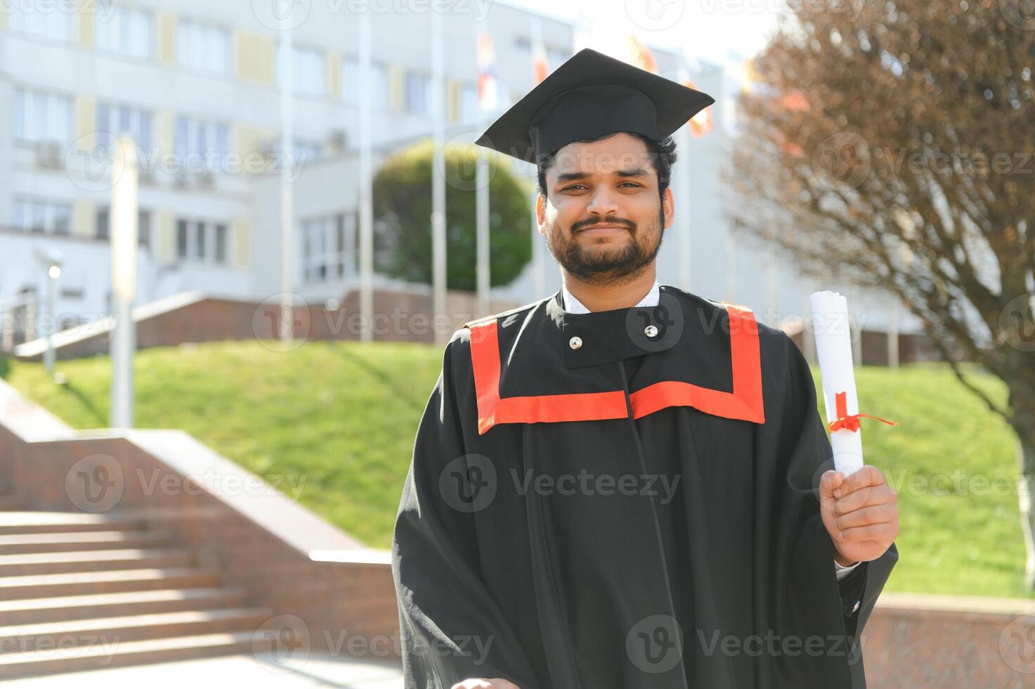 education, graduation and people concept - happy Indian Male graduate student photo