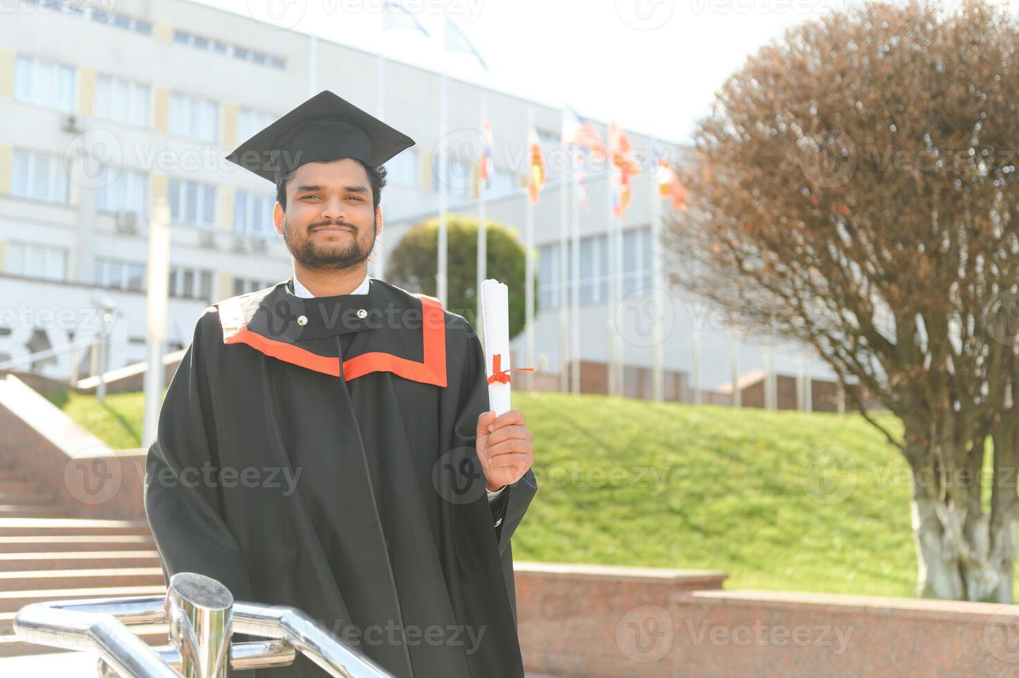 Portrait of happy man, graduation or student in university campus photo