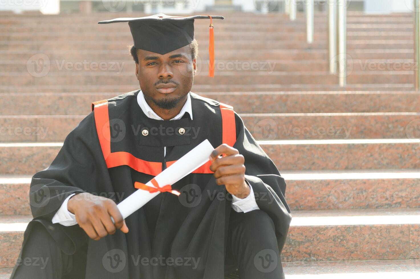 smiling african american graduated student showing diploma photo