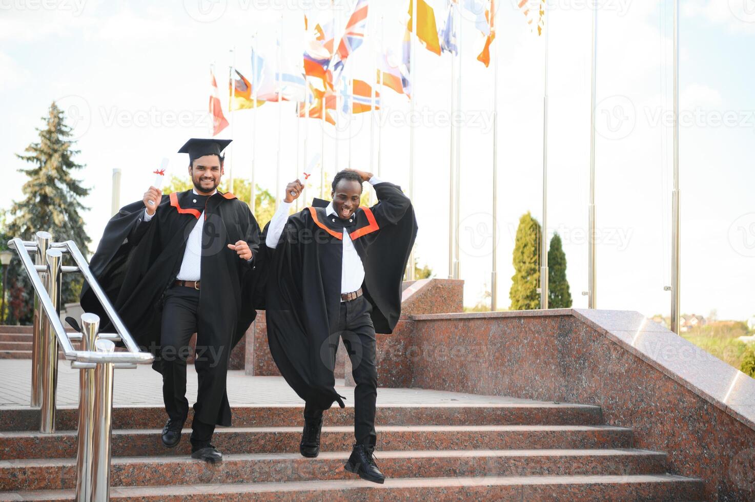 Two friends are university graduates. Indian and African graduates photo