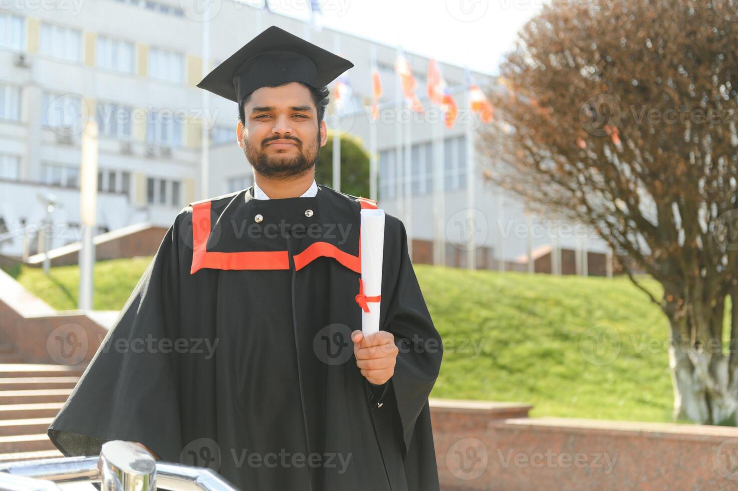 Portrait of happy man, graduation or student in university campus photo