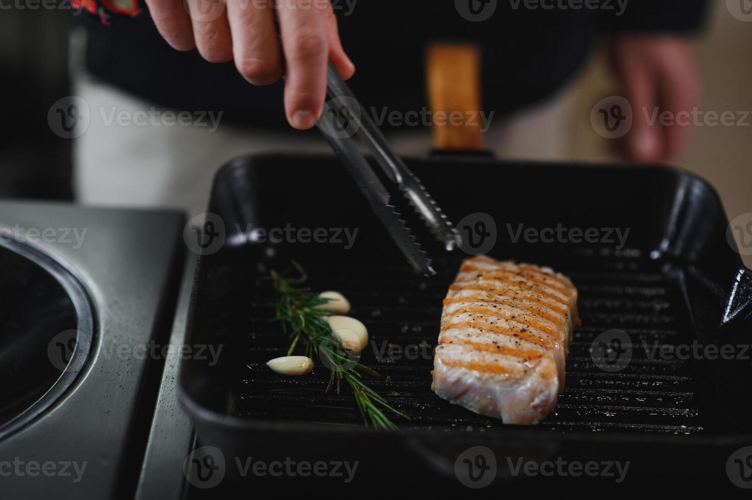 Chef cooks pork steak. Recipe book, cooking, restaurant business photo