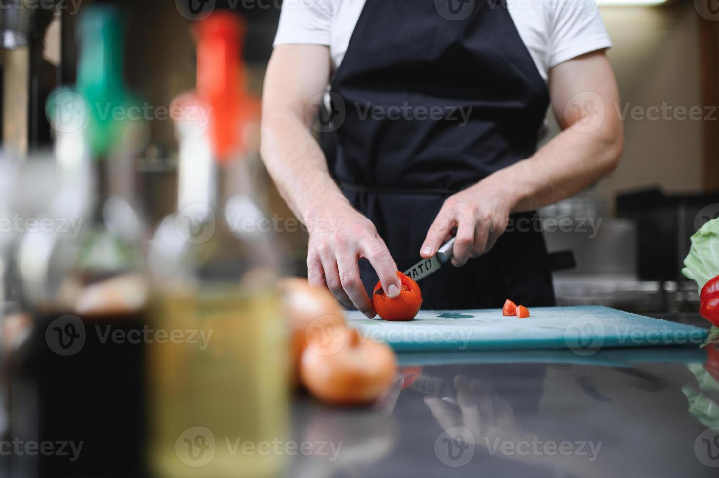Chef cook preparing vegetables in his kitchen photo