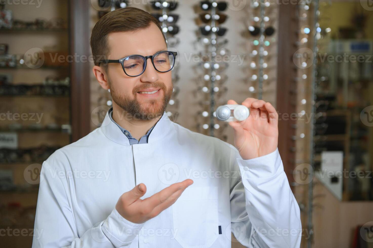 Doctor holds in his hand container with soft contact lenses for single use. Ophthalmologist prescribes use of one-day contact lenses for vision correction. Myopia and eyesight problem concept. photo