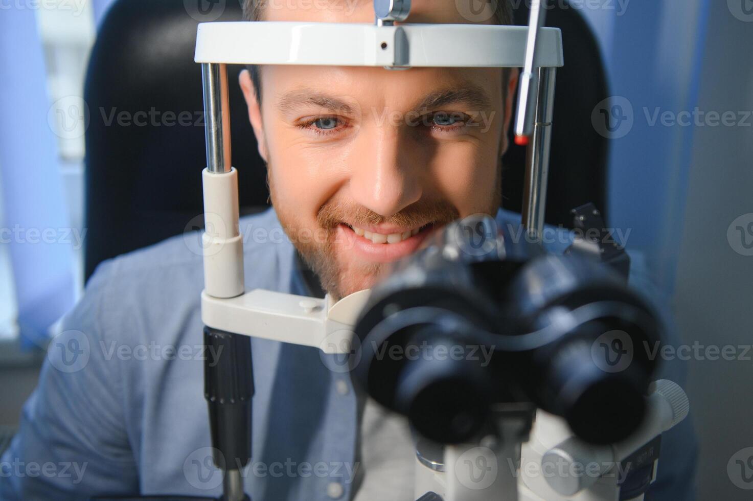 Ophthalmology concept. Male patient under eye vision examination in eyesight ophthalmological correction clinic photo