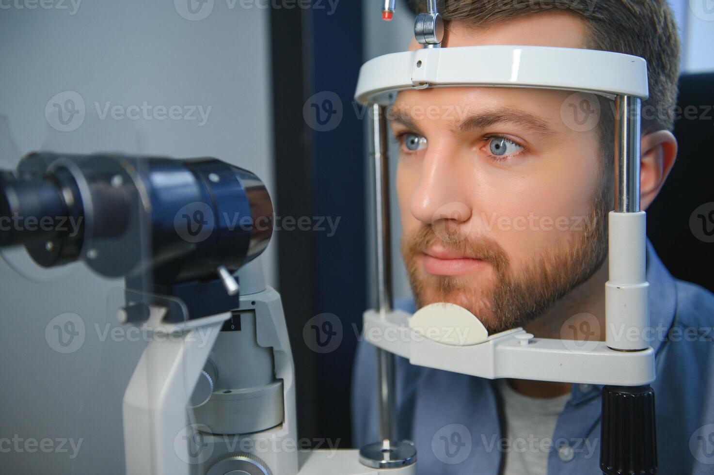 Ophthalmology concept. Male patient under eye vision examination in eyesight ophthalmological correction clinic photo