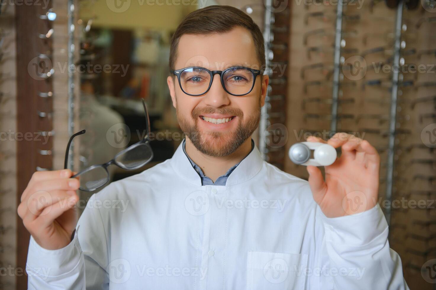 Eye doctor choosing between eyeglasses and lenses standing in the cabinet photo