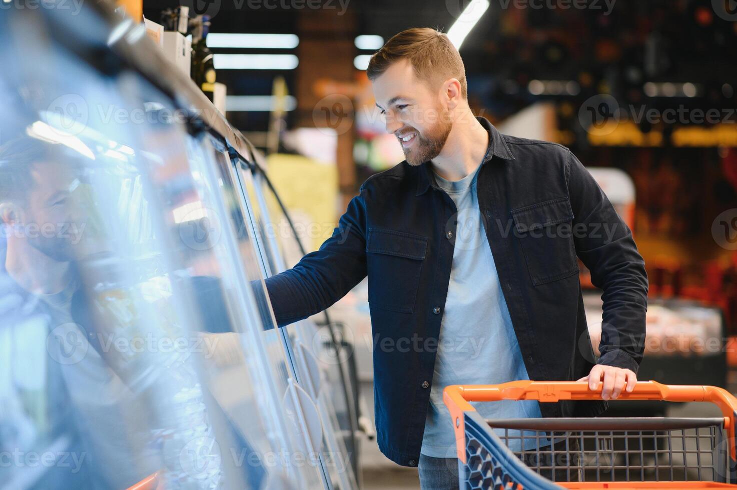 Young man shopping in grocery store. Shopping concept photo