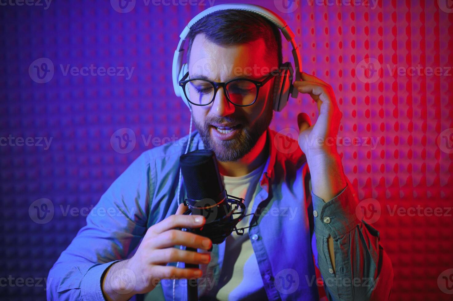 A blogger records content in his studio. The backstage photo was taken from behind one of the participants in the shooting, at the beginning of the shooting when the blogger is preparing.