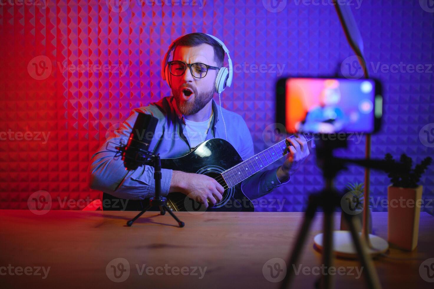 Man singing in a recording studio photo