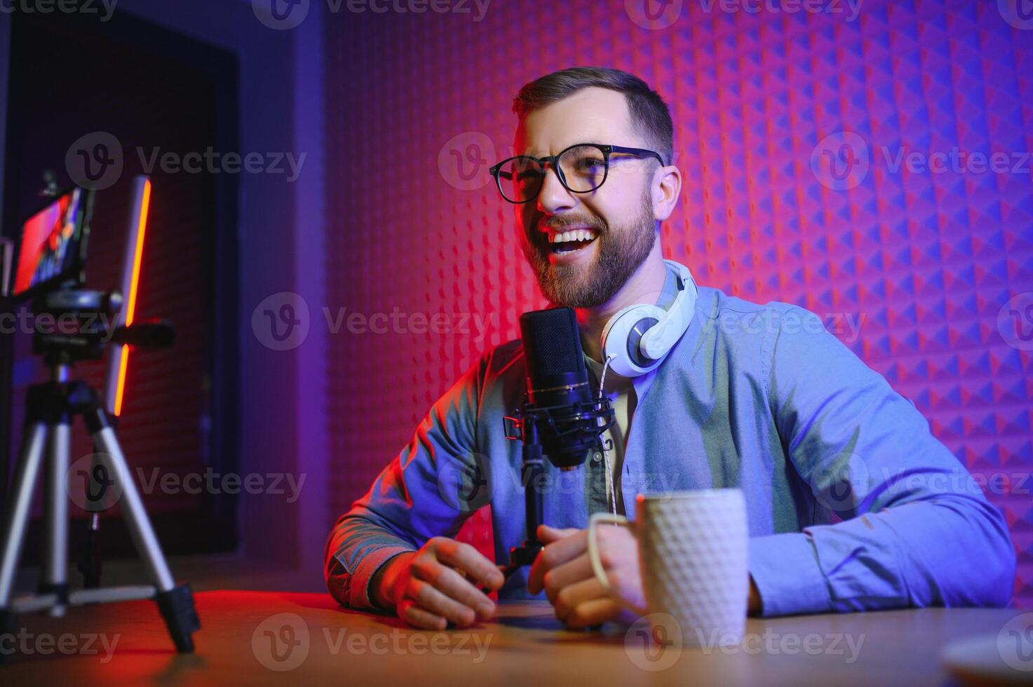 A blogger records content in his studio. The backstage photo was taken from behind one of the participants in the shooting, at the beginning of the shooting when the blogger is preparing.