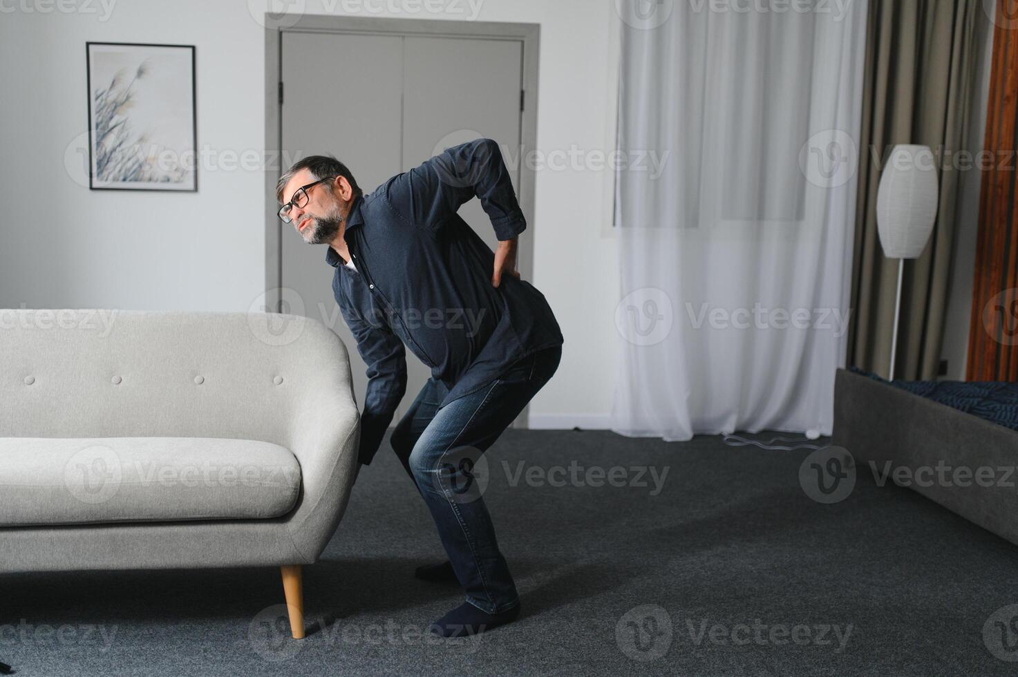 Senior man with back pain. Mature man suffering from low back pain. Old man with back pain photo