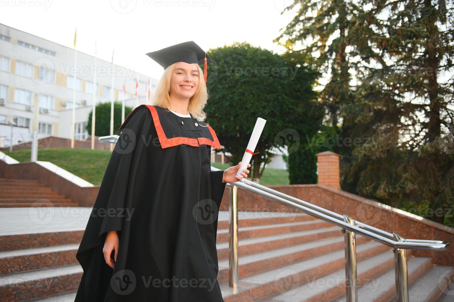 Portrait of a happy woman on her graduation day at university. Education and people. photo