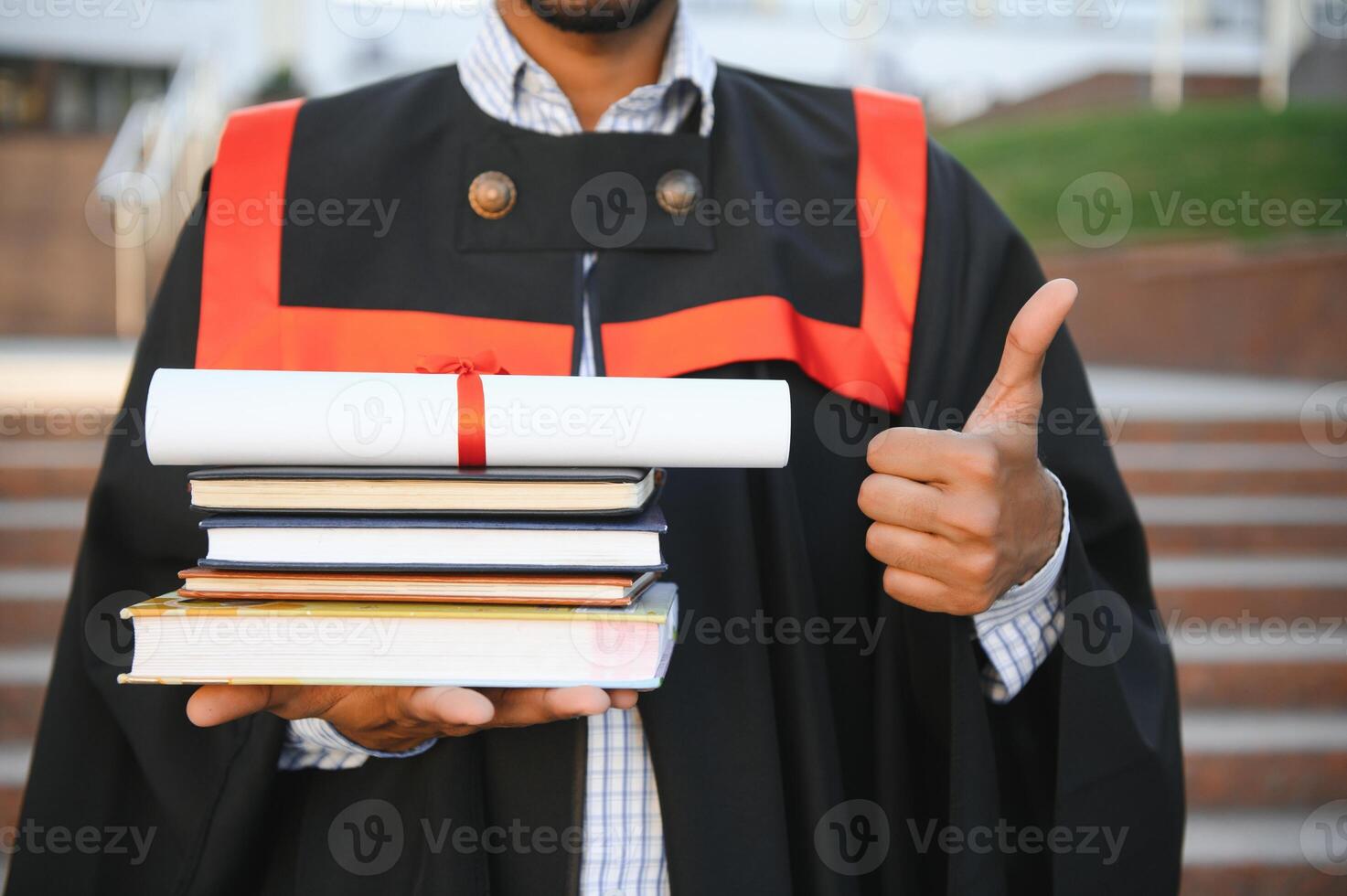 Handsome indian graduate in graduation glow with diploma. photo