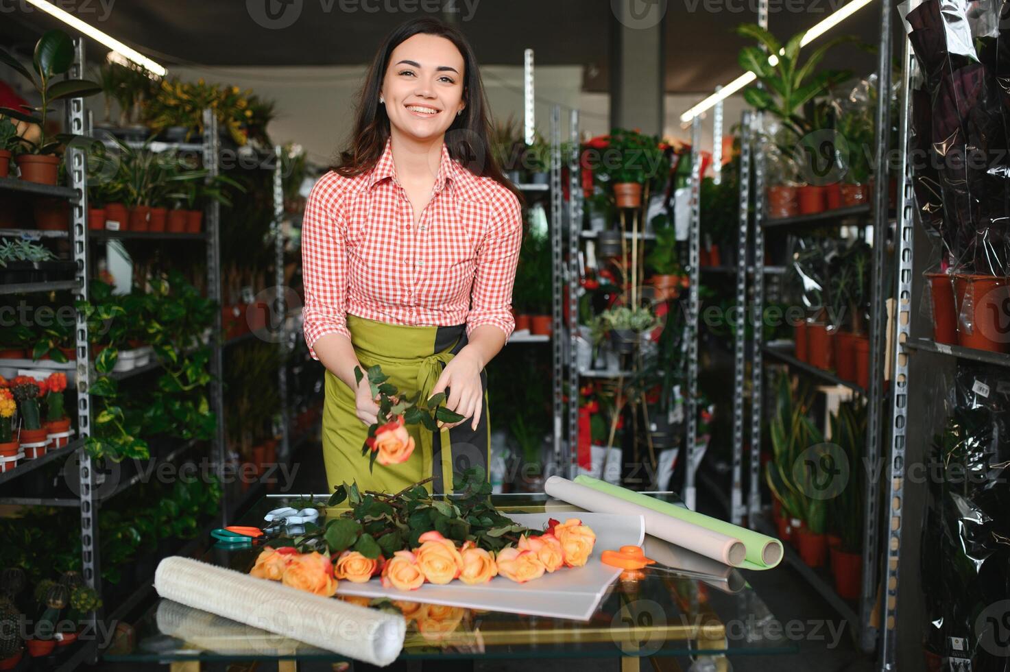 Portrait of female florist in her flower shop. photo
