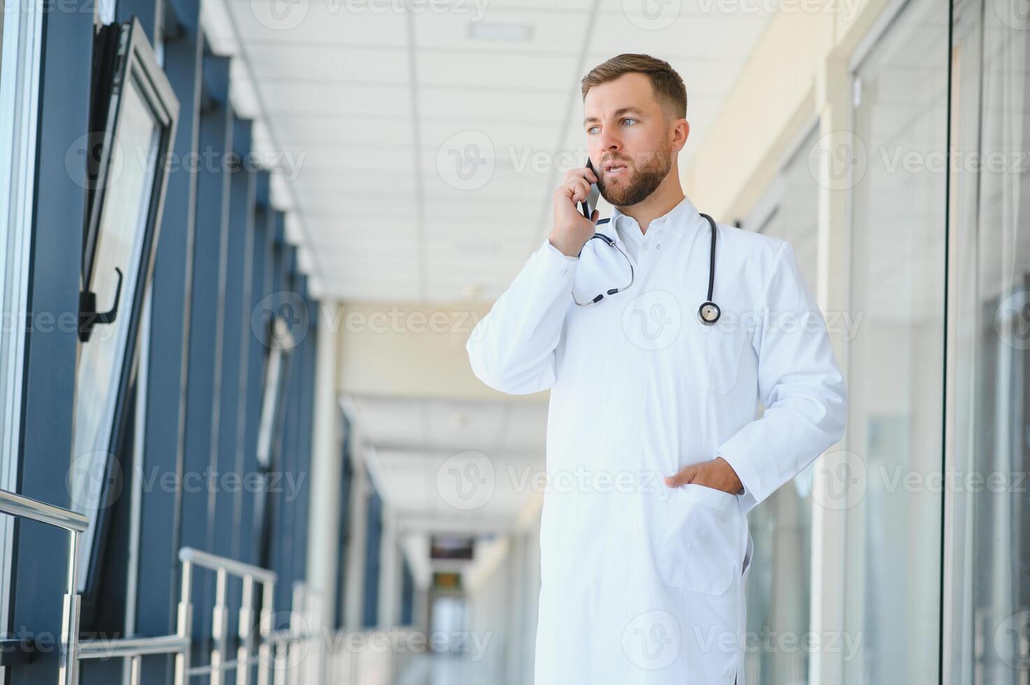 Young male doctor in a corridor of a general hospital photo